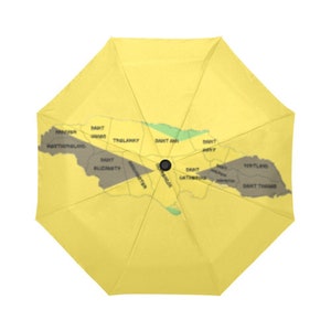 May include: A yellow umbrella with a map of the Caribbean island of Antigua and Barbuda printed on the inside. The map shows the different parishes of the island, including Saint John, Saint Mary, Saint Paul, Saint Peter, Saint Philip, Saint George, Saint Thomas, Saint Andrew, Saint David, Saint George, and Saint Mary.