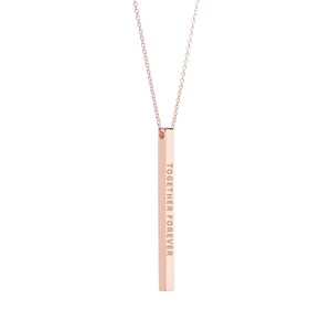 May include: A rose gold necklace featuring a vertical bar pendant. The pendant is inscribed with the words "TOGETHER FOREVER" in a vertical orientation. The necklace has a delicate chain and a simple, elegant design.