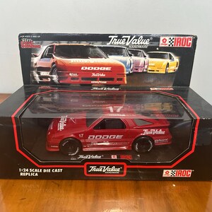 May include: A red Dodge race car replica in a black box. The model car is a 1:24 scale die-cast replica with the number 17 on the side and top. The box features the True Value Hardware and IROC logos.