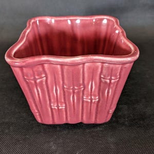 May include: A set of three ceramic mugs with a speckled, matte finish. The mugs are in shades of cream, light gray, and dark gray. Each mug has a simple, minimalist design and a rounded handle.