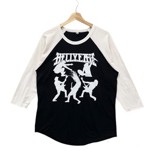May include: Black and white baseball style t-shirt with a white graphic of a band called "HELLYEAH" with a silhouette of five people playing guitars. The shirt has white sleeves and a black body.