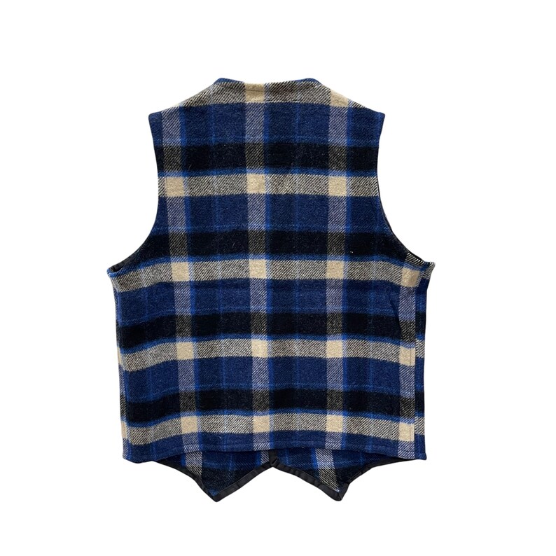 May include: A sleeveless vest featuring a plaid pattern in shades of blue, black, and cream. The garment has a high neckline, a straight back hem, and two pointed front panels that overlap at the center. The fabric has a textured, woven appearance.