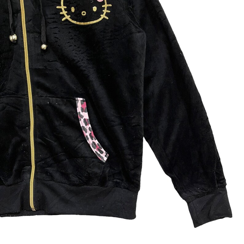Pode incluir: Casaco de moletom preto de veludo com z&iacute;per, com um gr&aacute;fico dourado de Hello Kitty e um detalhe de bolso com estampa de leopardo rosa e preto.