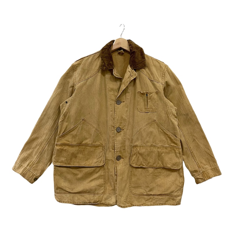 May include: A brown corduroy-collared work jacket with multiple pockets and a button-up front.