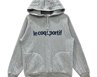 Sudadera con capucha y estampado Spell Out de Le Coq Sportif.