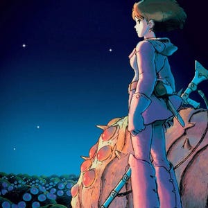 May include: Poster for the animated film "Nausica&auml; of the Valley of the Wind." The image features a character in a purple outfit standing on a large, insect-like creature. The background is a dark blue sky with stars.