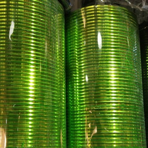 May include: A stack of shiny green bangles, wrapped in plastic, ready for sale.
