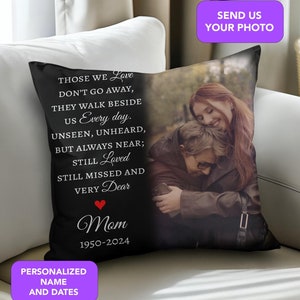 May include: Black throw pillow with a photo of two women hugging. The pillow has the text "Those we love don't go away, they walk beside us every day. Unseen, unheard, but always near; still loved, still missed and very dear. Mom 1950-2024".