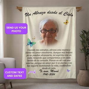 May include: A white memorial tapestry with a photo of an older woman wearing glasses. The tapestry has the text "Un Abrazo desde el Cielo" at the top and "Te amo. Mamá 1940-2024" at the bottom. The text reads "When you miss me, hug this blanket and feel my love envelop you. Although my arms can no longer reach you, my spirit lives in every memory we shared and in every beat of your heart. Think of me with a smile, because my love for you is eternal and my light will continue to illuminate your life, taking care of you from heaven."