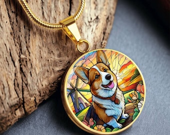 May include: A gold chain necklace with a round pendant featuring a colourful stained glass style illustration of a corgi dog in a field with a windmill and a sunset.