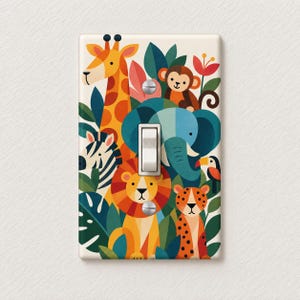 May include: A rectangular light switch cover plate featuring a colorful jungle theme with a giraffe, monkey, elephant, zebra, lion, leopard, and toucan among green leaves and red flowers. The plate has a central white toggle switch and two screws.