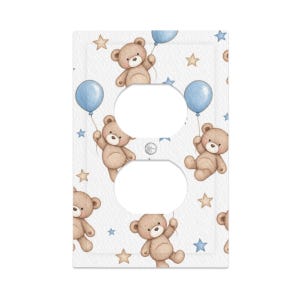 May include: A rectangular light switch wall plate featuring a repeating pattern of light brown teddy bears holding blue balloons against a white background with scattered small tan and blue stars. The plate has two circular cutouts for outlets.