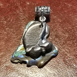 Asymmetric silver droplet mounted on Paul shell to make a gorgeous pendant