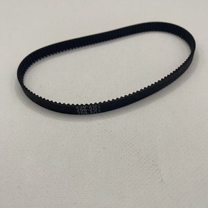 May include: A black rubber timing belt with the text "250-2GT 250-2GT 250-2GT" printed on it.