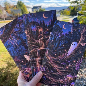 May include: Three rectangular bookmarks featuring dark, atmospheric illustrations of a moonlit forest. The designs include a glowing fountain, a small white ghost, purple flowers, moths, and a crescent moon set against a deep blue sky.