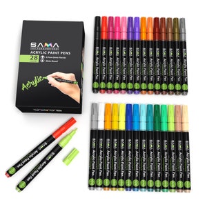 May include: A set of 28 acrylic paint pens with a variety of colors. The pens have a 0.7mm extra fine tip and are water-based. The pens are arranged in two rows, with the top row containing 14 pens and the bottom row containing 14 pens. The pens are all black with a silver cap and a green label that says "SAMA Acrylic Paint Pen".