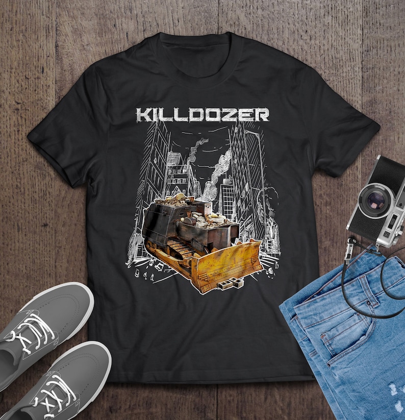 May include: Black t-shirt with a white graphic of a bulldozer driving through a city with the text "KILLDOZER" above it.