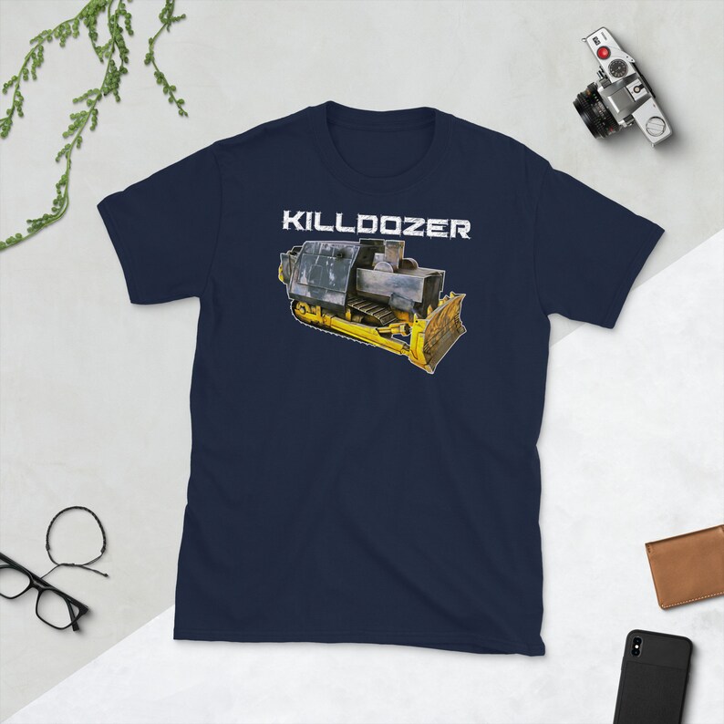 May include: A navy blue t-shirt featuring a white graphic of a yellow bulldozer with the text "KILLDOZER" above it.