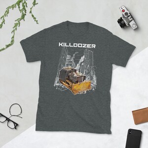 May include: A dark heather grey t-shirt with a white graphic of a bulldozer in a city setting. The text "KILLDOZER" is printed in white above the bulldozer.