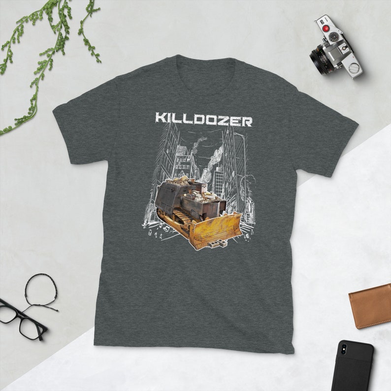 May include: A dark heather grey t-shirt with a white graphic of a bulldozer in a city setting. The text "KILLDOZER" is printed in white above the bulldozer.
