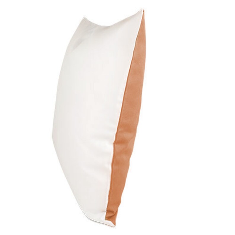 May include: A white pillow with a brown accent on one side. The pillow is made of a soft, comfortable fabric.