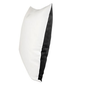 May include: A white pillow with a black border. The pillow is made of a soft, comfortable fabric and is perfect for adding a touch of style to any room.