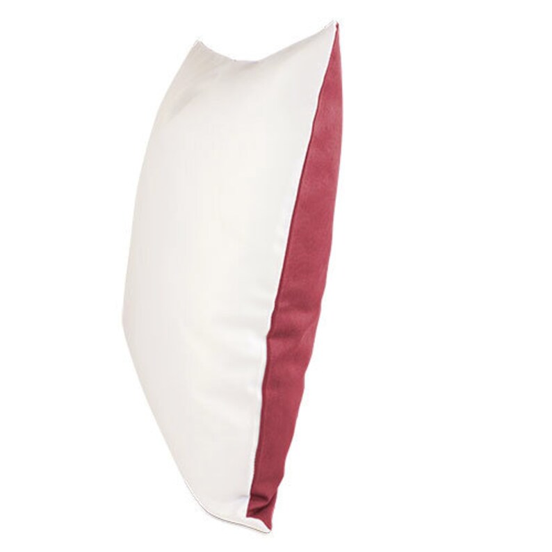 May include: A white pillow with a burgundy colored border. The pillow is made of a soft, comfortable fabric.