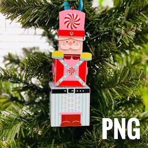 May include: A colorful wooden nutcracker ornament with a pink hat, red jacket, and blue pants. The ornament is decorated with candy canes and a white and blue striped pattern.