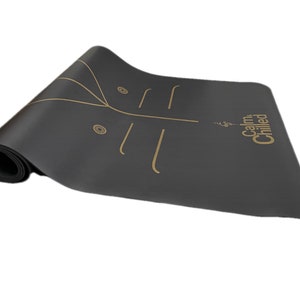 May include: Black yoga mat with gold lines and the text "Calm & Chilled" printed on the mat.