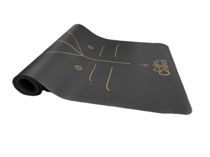 May include: Black yoga mat with gold lines and the text "Calm & Chilled" printed on the mat.
