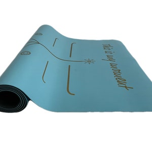 May include: A light blue yoga mat with a gold design and the text "This is my moment".