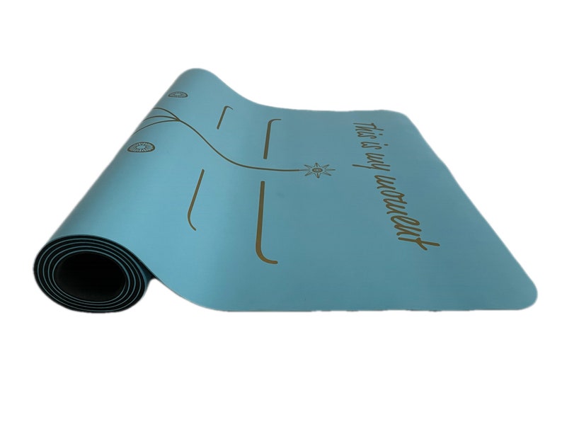 May include: A light blue yoga mat with a gold design and the text "This is my moment".