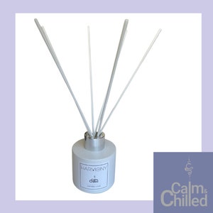 May include: A white diffuser bottle with a silver lid and white reeds. The bottle has the text "HARMONY" and "Calm & Chilled" printed on it.