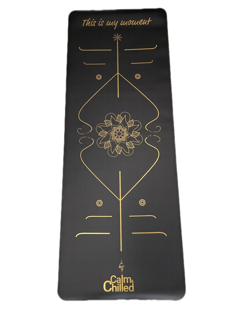 May include: Black yoga mat with gold lettering and a mandala design. The text reads "This is my moment" and "Calm & Chilled".