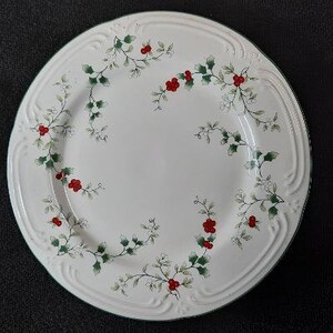 May include: White ceramic dinner plate with a green and red holly and berry design.