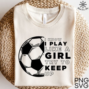 May include: A white t-shirt with a black and white football graphic and the text "I know I play like a girl try to keep up".