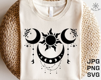 May include: A white t-shirt with a black design of a sun and two moons with stars and beads. The design is centered on the shirt.