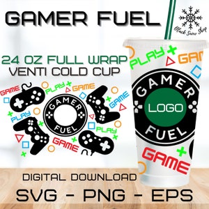 May include: A digital download design for a 24 ounce cold cup featuring a gamer theme. The design includes a black and green circle with the text "Gamer Fuel" and a logo placeholder. The cup is surrounded by black and white game controllers and the words "Play", "Game", and "Gamer Fuel".