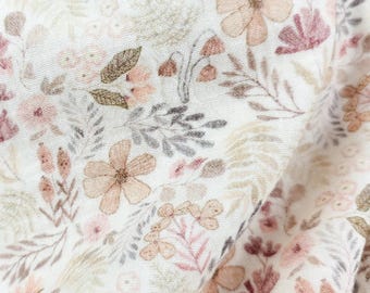 May include: Close-up of a white fabric with a delicate floral pattern. The design features various flowers and foliage in soft, muted tones of pink, beige, and gray. The fabric has a slightly textured appearance.