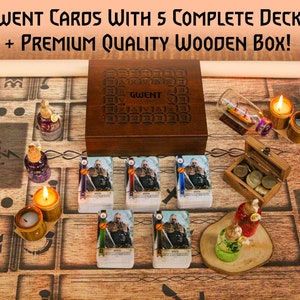 May include: A wooden box set of Gwent cards with 5 complete decks. The box is dark brown with the word "Gwent" on the lid. The set includes a wooden game board, candles, and decorative items. The text on the image reads "Gwent Cards with 5 Complete Decks + Premium Quality Wooden Box!"