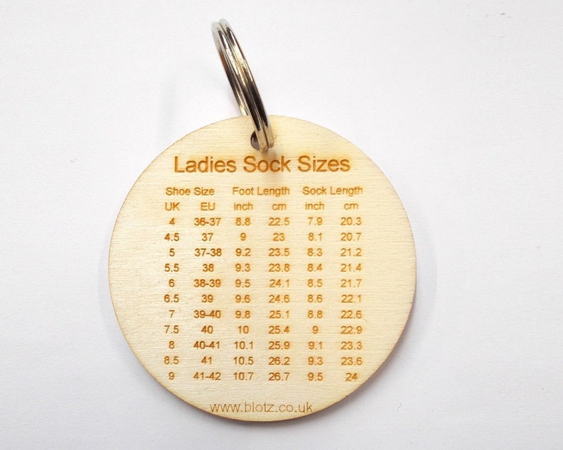 May include: A wooden keychain with a metal ring, featuring a chart titled "Ladies Sock Sizes." The chart lists shoe sizes in UK and EU, along with foot and sock lengths in inches and centimeters. The website www.blotz.co.uk is printed at the bottom.