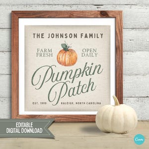 May include: A framed sign with the text "Pumpkin Patch" and an orange pumpkin illustration. The sign also includes the text "The Johnson Family", "Farm Fresh", "Open Daily", "Est. 1999", and "Raleigh, North Carolina". A white pumpkin sits to the right.