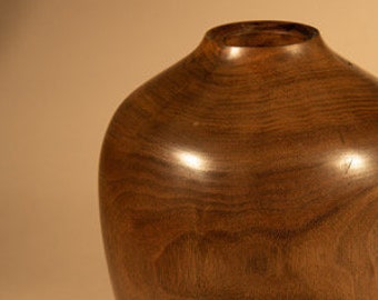 Stunning Walnut vase with hand carved legs