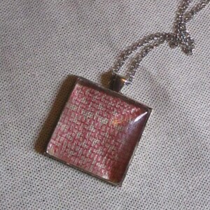 Embroidered pendant with chain, embroidered in style of blackwork with pink thread