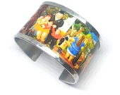 Aluminum bracelet inspired by the family of Fernando Botero. Personalized text