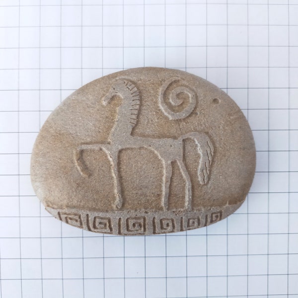 Rock carved with the motif of an Etruscan horse.