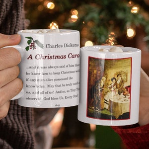 May include: Two white ceramic mugs with a Christmas theme. The mug on the left has the text "Charles Dickens A Christmas Carol" and a quote from the book. The mug on the right has a vintage illustration of a Christmas scene.