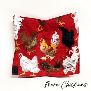 May include: Red fabric pot holder with a chicken pattern. The pot holder features a variety of chickens, roosters, and hens in different colors and patterns. The background is a red honeycomb pattern.