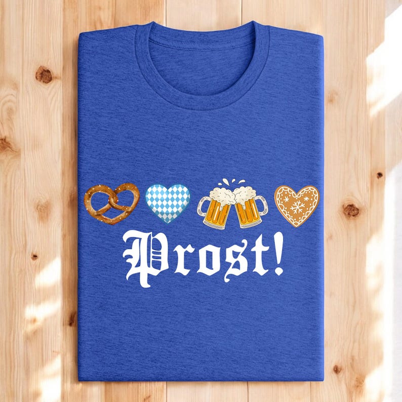 A blue t-shirt with the text "Prost!" printed on it, along with four heart-shaped icons and two beer mug icons.