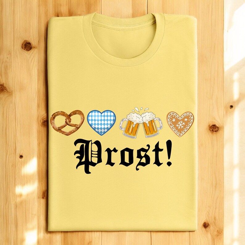 A yellow t-shirt with a graphic design featuring four heart-shaped icons and beer mugs, along with the text "Prost!"